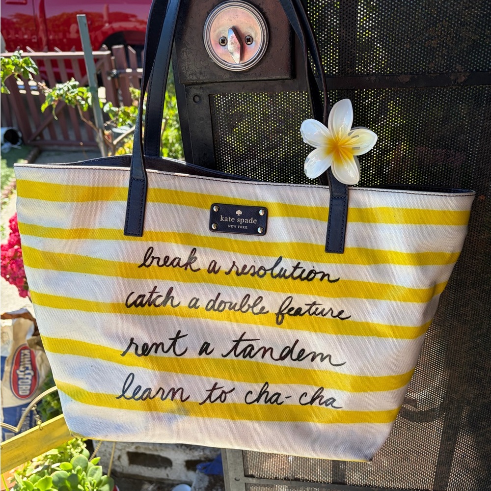 Kate Spade "Break A Resolution" Coal tote bag in yellow and navy striped canvas.